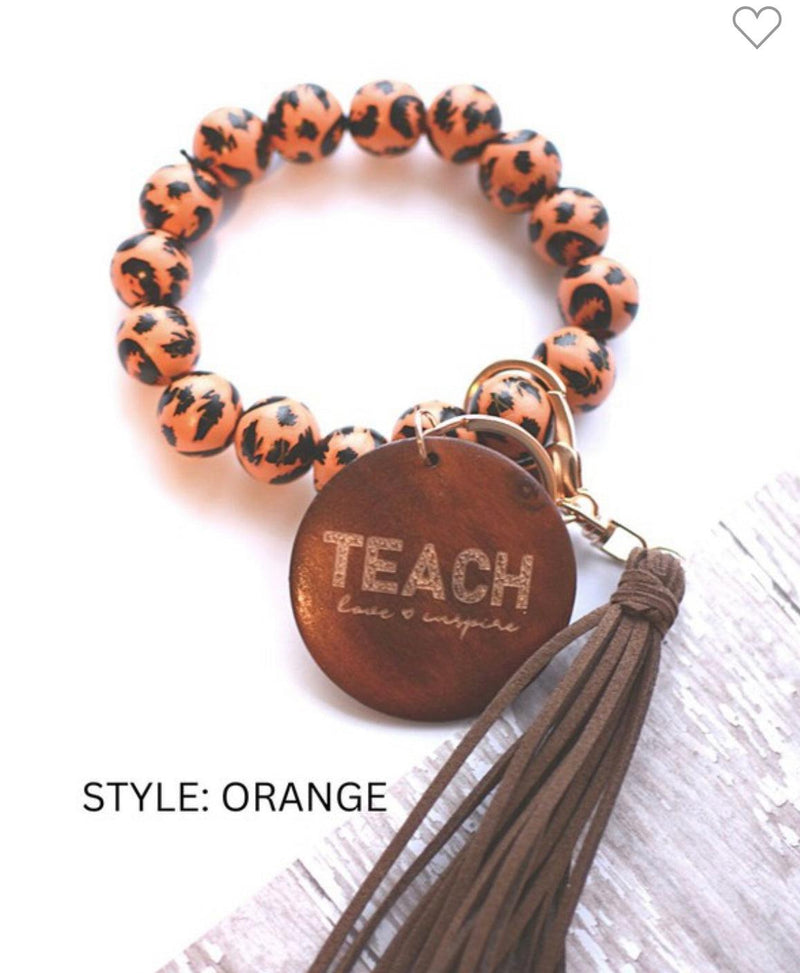 Teach orange bangle with tassel